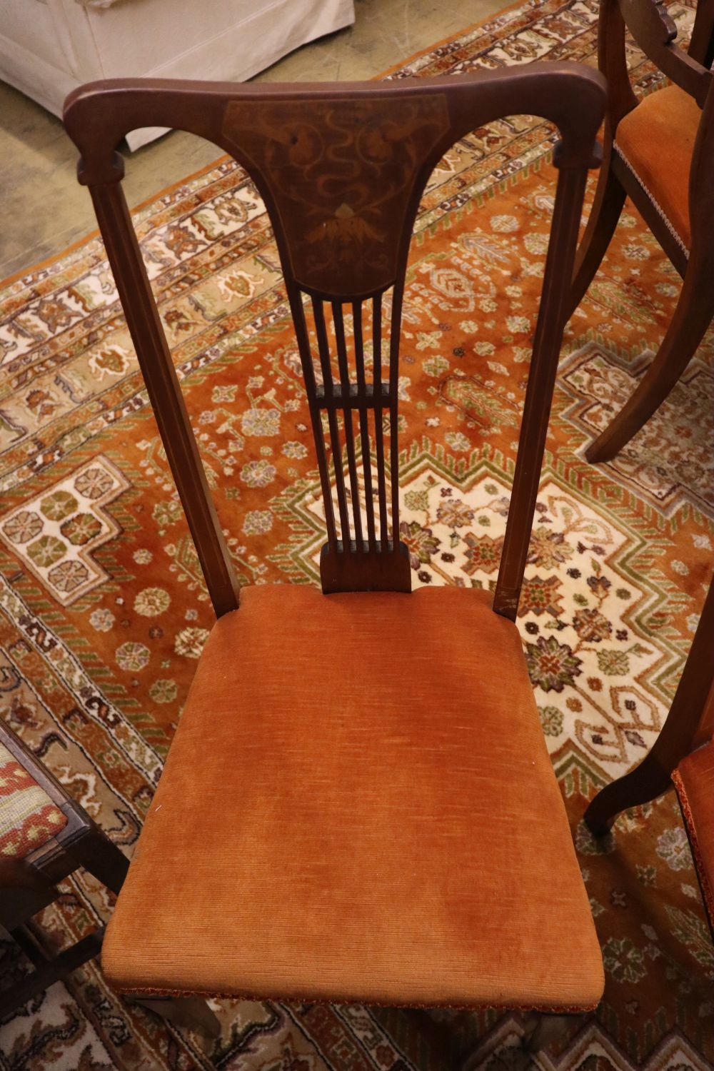 A set of four Hepplewhite style dining chairs (3 single, 1 arm) and four Edwardian dining chairs